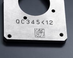 Metal part engraved with a serial number and a dot peen Datamatrix code 