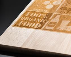 Decorative food-themed wood plate with engraved illustrations and text