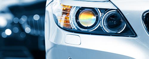 Close-up of the front left of a white car 