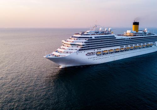 Leisure and cruise ship on sea, with setting sun